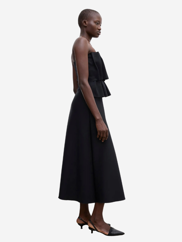 Model wearing the Sculpted Tube Dress in Black by House of Dagmar, highlighting its elegant a-line silhouette.