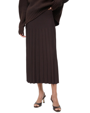 Model wearing the Lena Skirt in Earth by Staud, perfect for a chic and casual look.