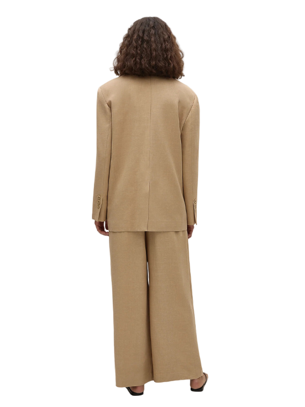 Full view of the Astrid Trouser in Sahara, featuring pleats, wide leg silhouette, and cropped ankle length.