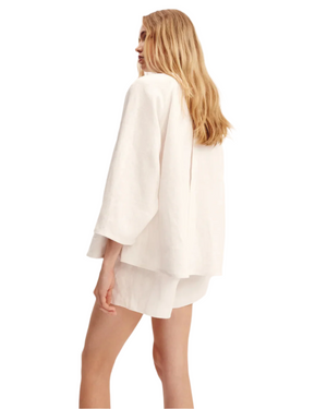 Olivia Blouse in Ivory displayed on a model, a versatile ivory blouse for women suitable for different occasions.