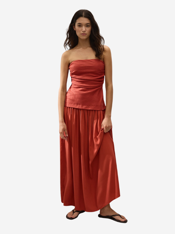 Side view of the Hedy Maxi Dress in Dusty Tomato, highlighting the drop waist and A-line soft skirt.