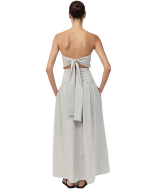 Model wearing the Gathered Strapless Tie Back Dress in Silver in a graceful pose, demonstrating its flowy A-line skirt and chic strapless design, a standout strapless tie back dress.