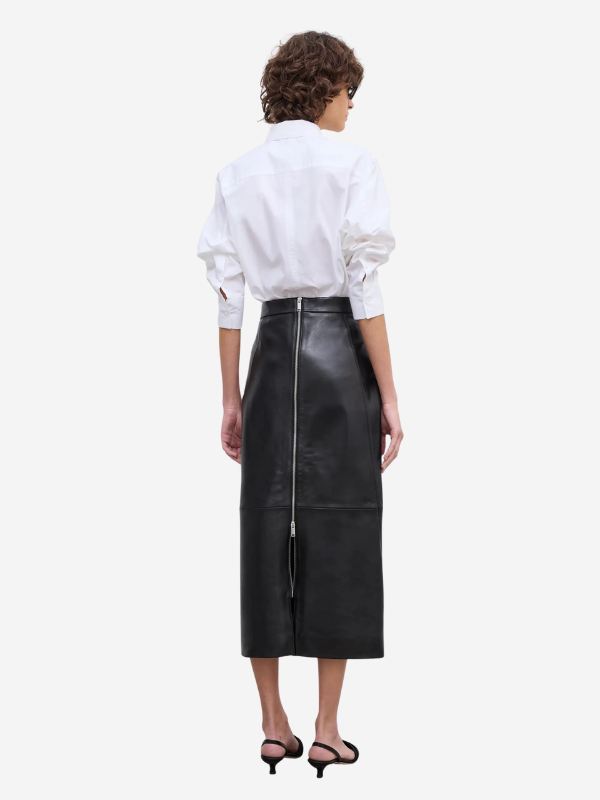 Close-up of House of Dagmar's Leather Midi Skirt in Black highlighting high-quality lambskin material.