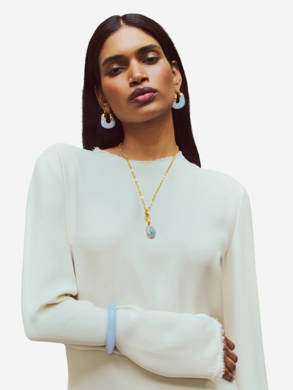 Close-up of the Yucca Pendant Necklace in Gold showcasing intricate stone inlays of blue lace agate and chrysoprase.