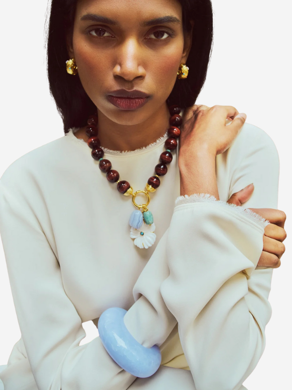 Close-up view of the Arc Cuff in Marbled Blue Lace, highlighting the elegant marbled resin texture and its snug fit on the forearm.