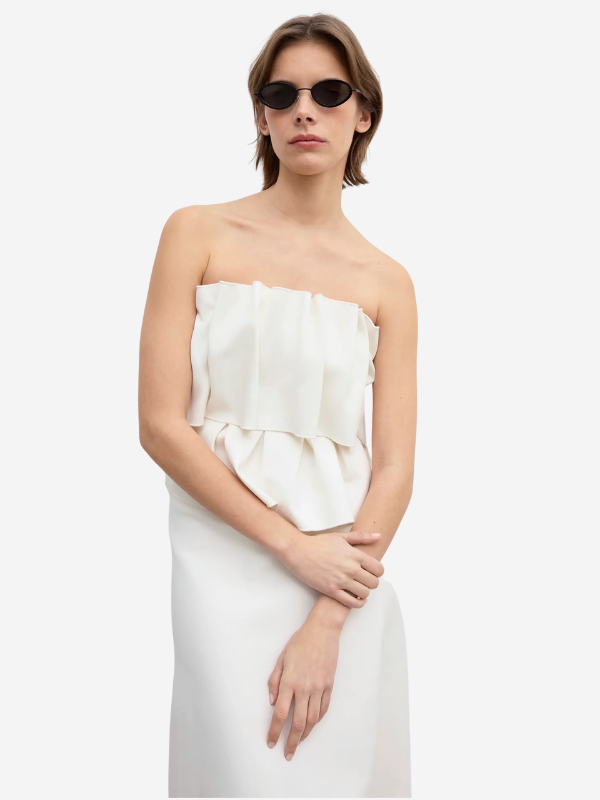 Flat lay of the Sculpted Tube Dress in White by House of Dagmar, showcasing its clean lines and chic style perfect for various occasions.