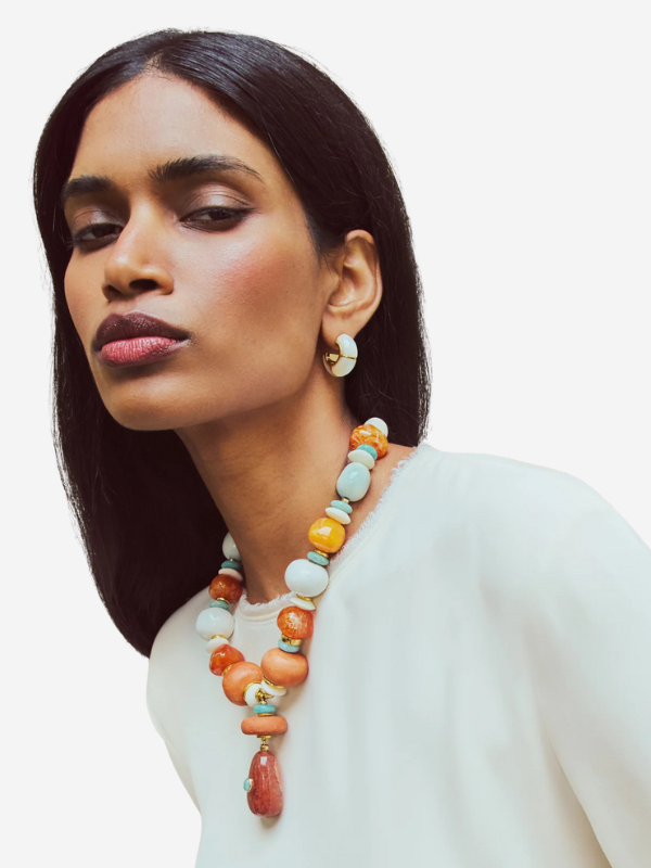 Stylish display of the Andamento Necklace in Mandarina showcasing its vibrant colors and design elements by Lizzie Fortunato.