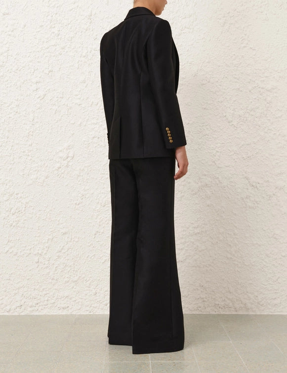 Model wearing the Hypnotic Tailored Jacket in Black, styled for a chic look, showcasing Zimmermann's Fall 2025 Collection.