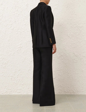 Model wearing the Hypnotic Tailored Jacket in Black, styled for a chic look, showcasing Zimmermann's Fall 2025 Collection.