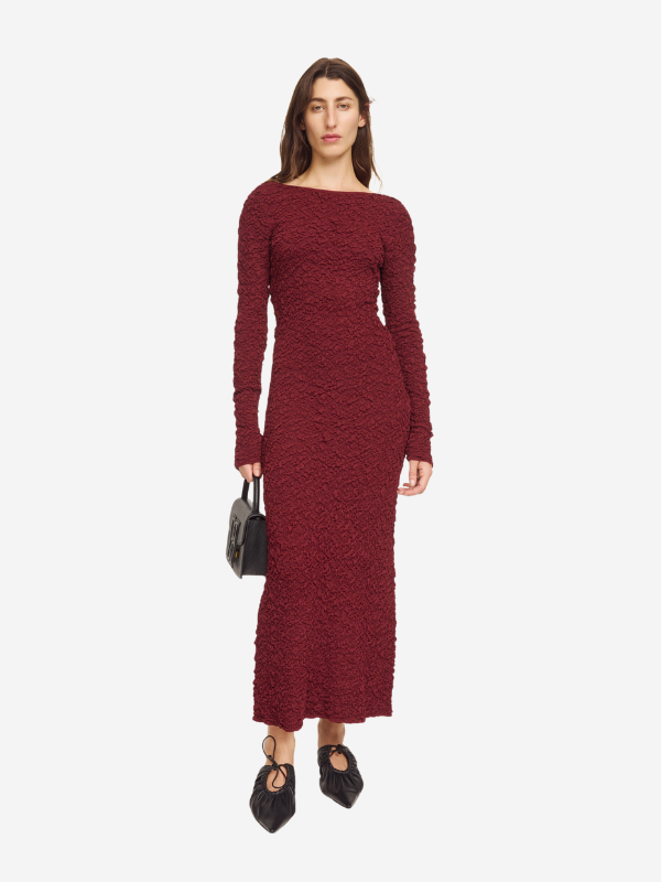 Close-up view of the Venus Dress in Cabernet by By Malene Birger, emphasizing the luxurious fabric and elongated sleeves.