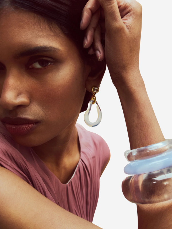 The Ridge Cuff in Marbled Blue Lace worn on the arm, demonstrating its snug fit and stylish look when stacked with other bracelets.