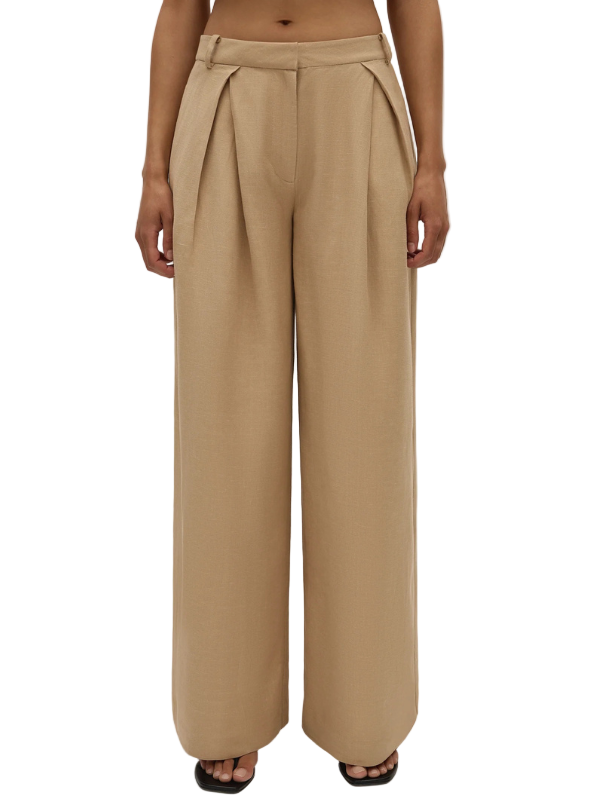 Model wearing Astrid Trouser in Sahara by FaithFull, styled casually for a contemporary look.