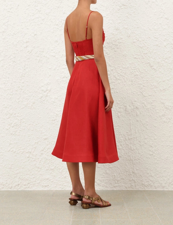 The Rebellion Tuck Midi Dress in Red drapes beautifully, perfect for a summer cruise or outdoor gathering.