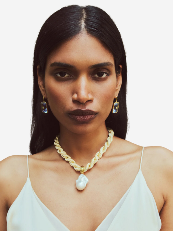 Close-up of the Woven Collar in Sandbar by Lizzie Fortunato with a detailed view of the gold-plated brass and pearl accent.