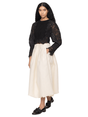 Full view of the Vania Sweater in Black, highlighting its cropped silhouette and modern vintage charm.