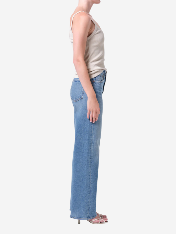 Model wearing Ren 32" Jean in Measure demonstrating its flattering high waist and elongated leg shape in a casual setting.