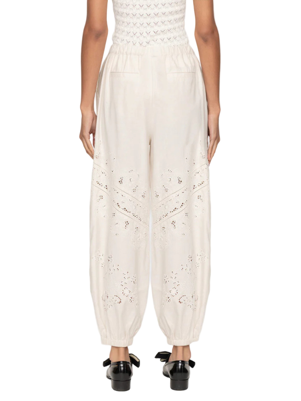 Lifestyle image of Shanna Lace Track Pants in Cream worn with a stylish top for a chic ensemble.