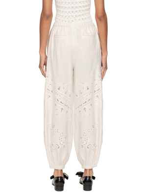 Lifestyle image of Shanna Lace Track Pants in Cream worn with a stylish top for a chic ensemble.