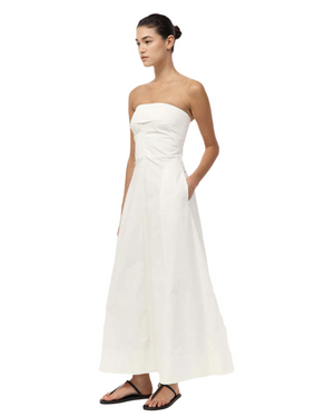 Close-up of the luxurious fabric of the Sculpted Cotton Strapless Dress in Milk.