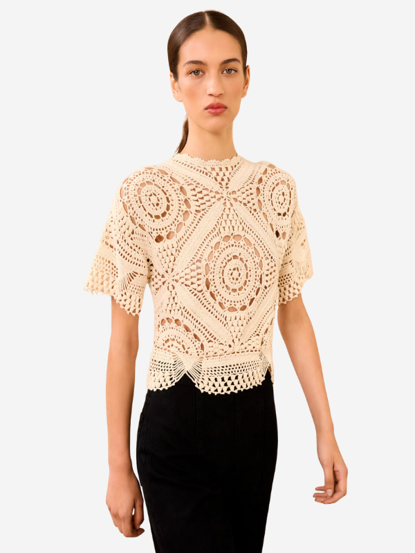 Model wearing the Maddalena Top in Cowrie, featuring unique open geometric designs that enhance its beauty.