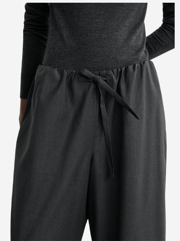 Back view of the Drawstring Dinner Trouser in Charcoal Melange illustrating the design and comfortable fit for stylish outfits.