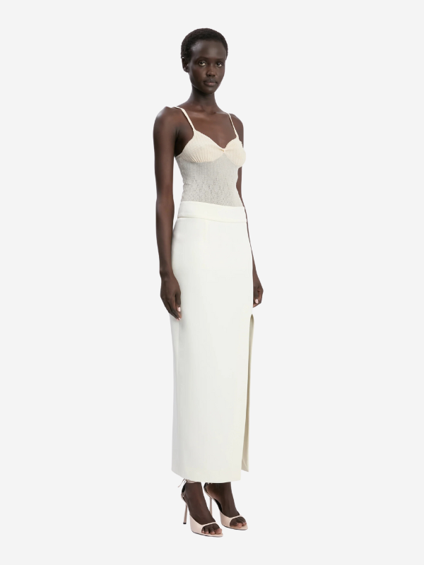Model wearing Split Detail Skirt in Ivory, highlighting its feminine silhouette and luxurious design.