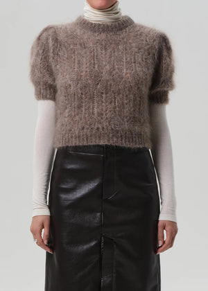 Model wearing Odette Puff Sleeve Sweater in Mushroom, demonstrating its chic layered look under tailoring.