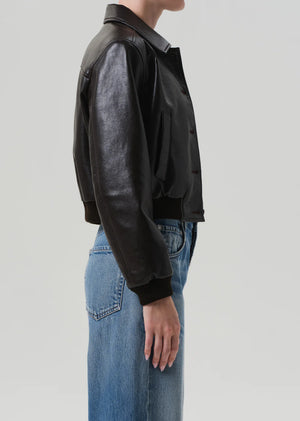 Model wearing the Lola Leather Bomber in Brown, perfectly styled over denim for a chic, modern look.