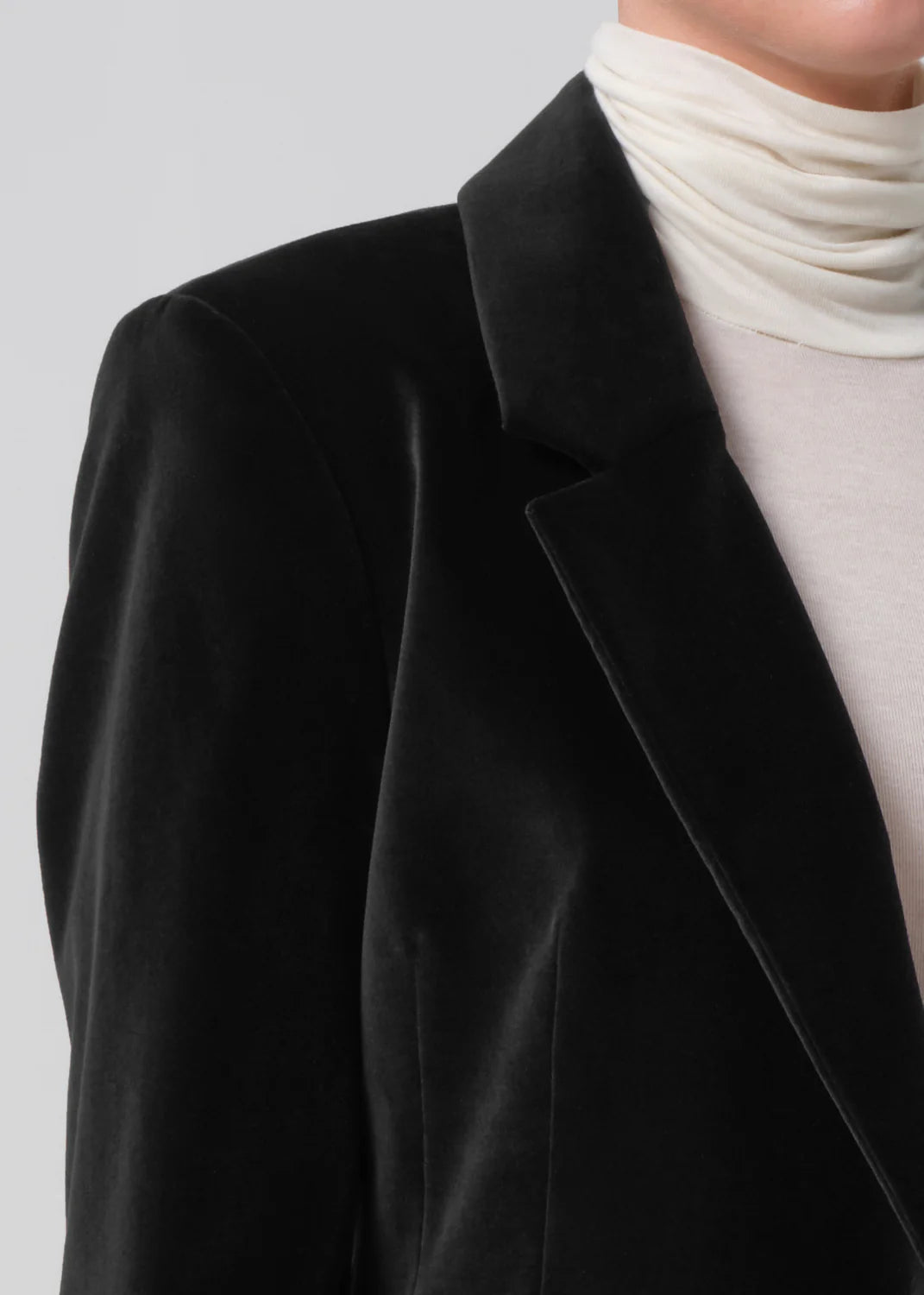 Side view of the Matteau Velvet Blazer in Black emphasizing its clean lines and refined structure.