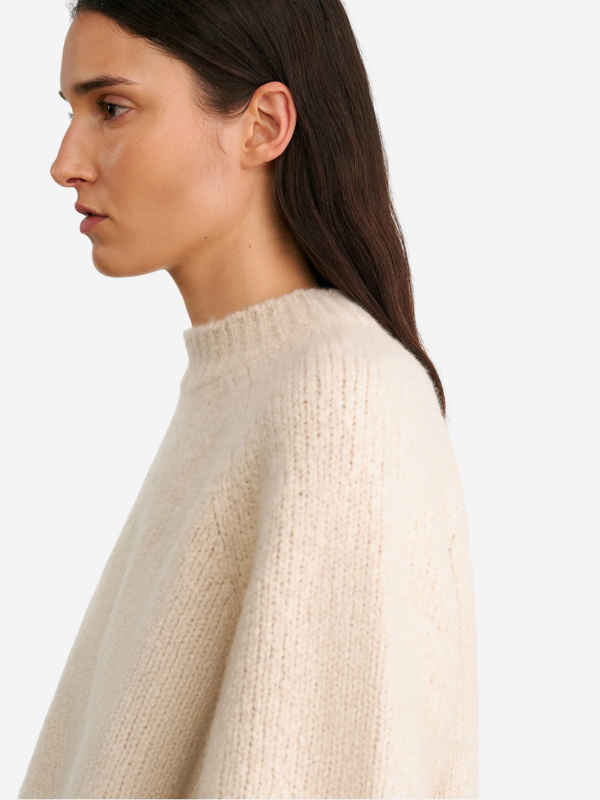 Flat lay of the Tomaso Sweater in Ivory by Nili Lotan, featuring the soft texture and elegant style fit for any season.
