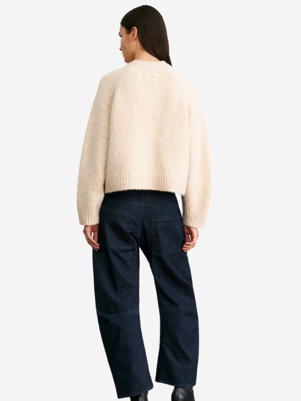 Side view of the Tomaso Sweater in Ivory by Nili Lotan, featuring a relaxed fit and raglan arm holes.