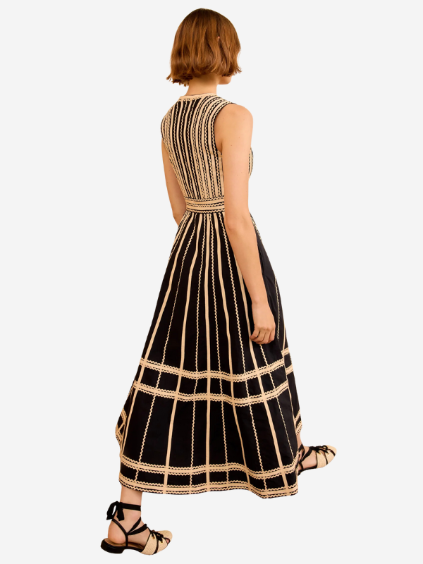 Model wearing the Palermo Dress in Noir with a form-fitting design and dramatic hem by Ulla Johnson.