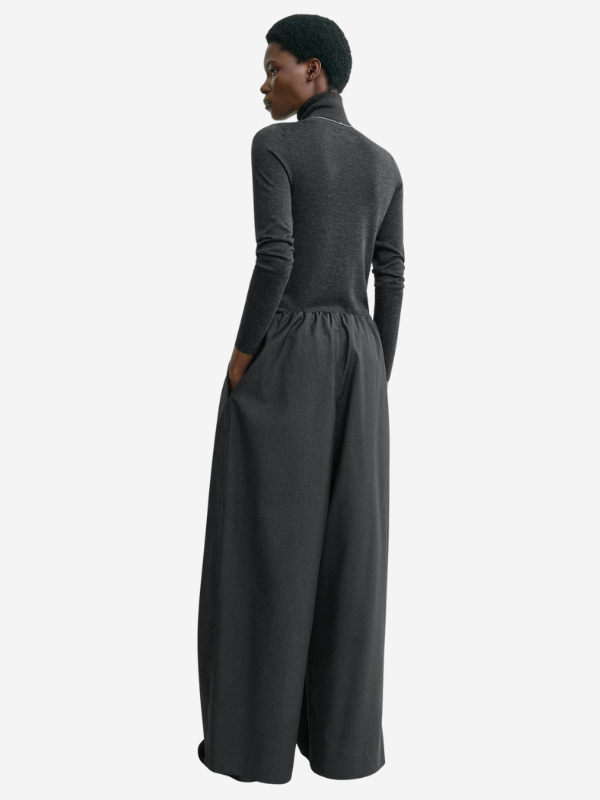 Side angle of the Drawstring Dinner Trouser in Charcoal Melange demonstrating its voluminous gathers and wide-leg silhouette.