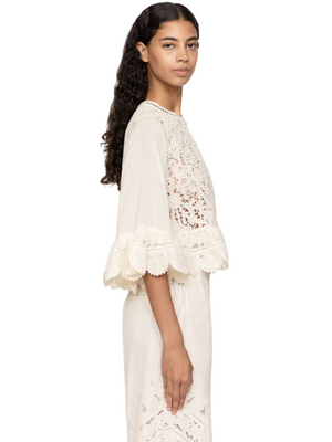 Model wearing the Shanna Lace Top in Cream featuring a cropped silhouette and sheer accents.