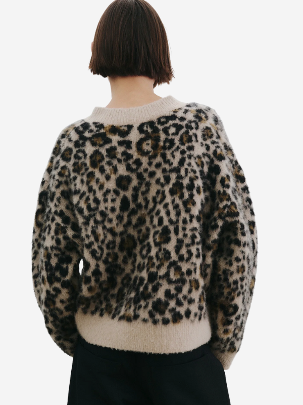 Model wearing the Nili Lotan Zamira Sweater in Jute Leopard, styled for a casual yet chic look.