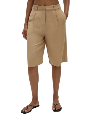 Model wearing Astrid Shorts in Sahara, demonstrating the versatility and comfort of FaithFull's bermuda style shorts.