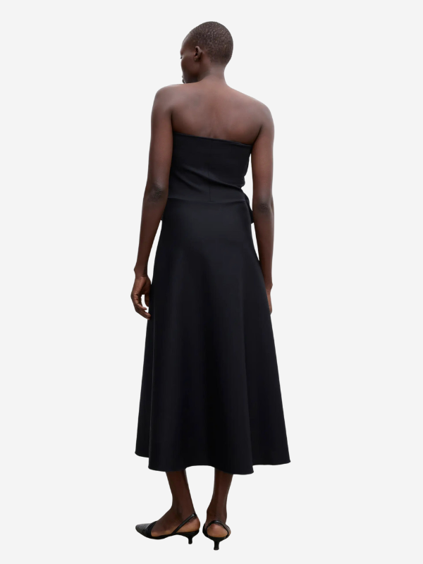 Back view of the Sculpted Tube Dress in Black from House of Dagmar, demonstrating its long, lean silhouette.