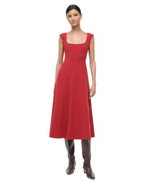 Close-up of the fabric texture of the Charlotte Dress in Rouge by Staud, highlighting its chic design and composition.