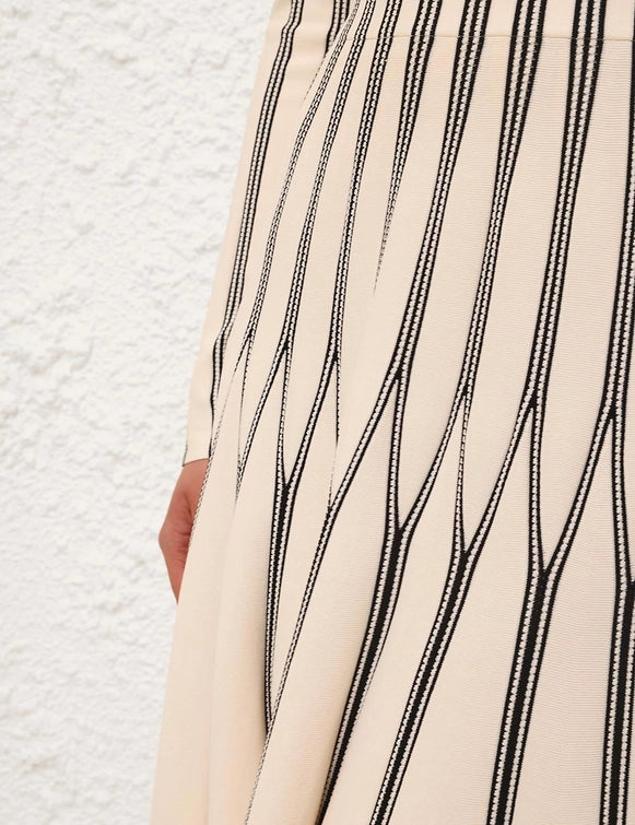 Rebellion Striped Midi Skirt in Cream Stripe displayed on a model, emphasizing the versatile and trendy design.