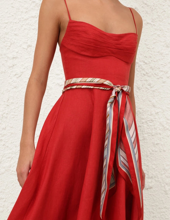 Side angle of the Rebellion Tuck Midi Dress in Red, capturing the full flare skirt and sophisticated design.