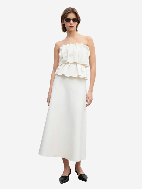 Close-up view of the Sculpted Tube Dress in White by House of Dagmar, highlighting the sculptural fabric texture and A-line skirt details.