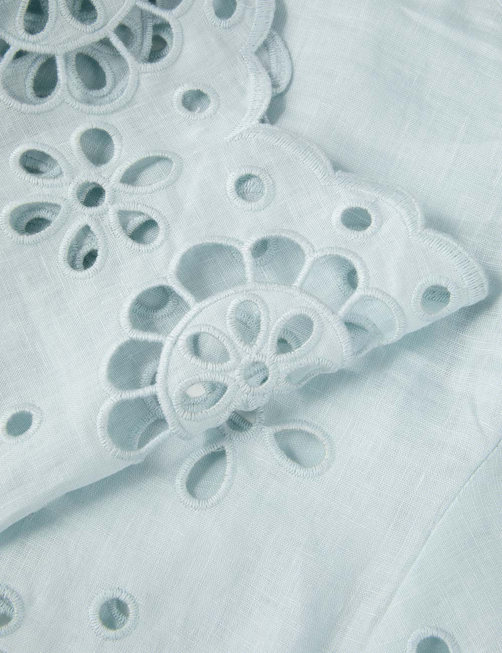 Awaken Embroidered Bodice in Mint displayed on a hanger with natural light.