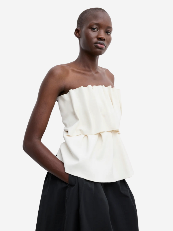 Model wearing the Sculpted Tube Top in White by House of Dagmar, highlighting its chic sleeveless design and elegant fabric.