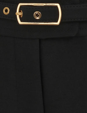 Lifestyle shot of Hypnotic Flare Pant in Black paired with stylish accessories, emphasizing fashion versatility.