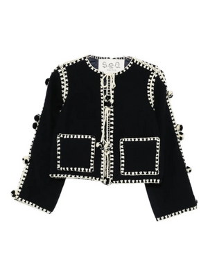 Addison Jacket in Navy featuring playful pom pom accents and crochet detailing, a stylish outerwear piece by SEA.