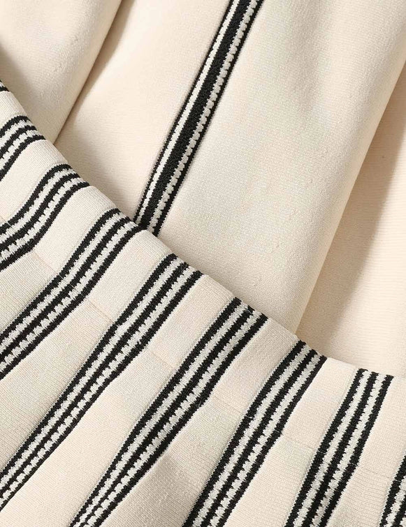 The Rebellion Striped Midi Skirt in Cream Stripe laid flat to show intricate detailing and composition of this Zimmermann piece.