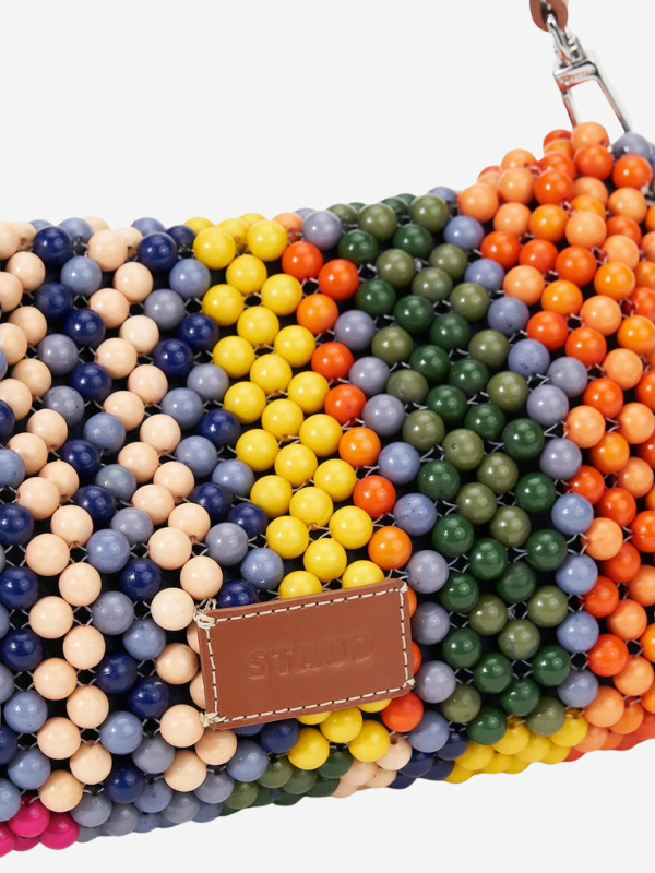 Lifestyle image of the Staud Timmy Shoulder Bag in Multi Bayadere Stripe being used in a casual outing.