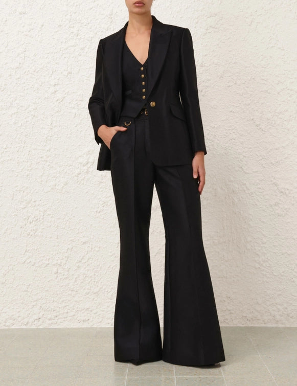 Side angle of Hypnotic Flare Pant in Black, displaying the flattering flared leg and tailored appearance.