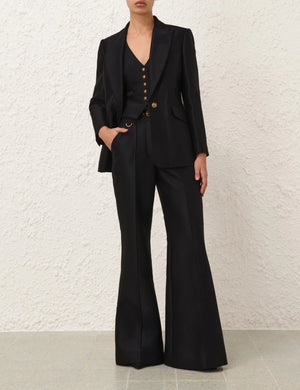 Side angle of Hypnotic Flare Pant in Black, displaying the flattering flared leg and tailored appearance.