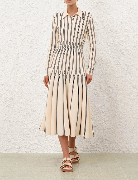 Rebellion Striped Midi Skirt in Cream Stripe photographed with natural lighting to showcase its elegant cream color.